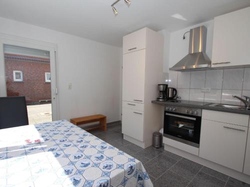 Apartment in Carolinensiel with a high chair and bed