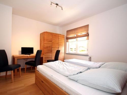 Apartment in Carolinensiel with a high chair and bed