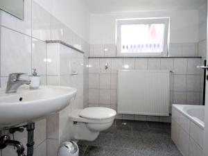 Apartment in Carolinensiel with a high chair and bed