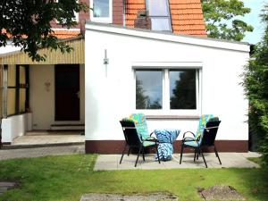 Apartment in Carolinensiel with a high chair and bed