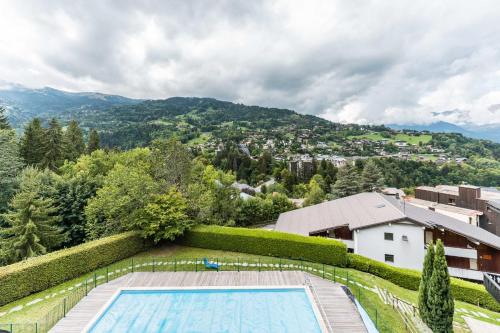 Apartment with balcony and swimming pool in summer Alpenrose residence