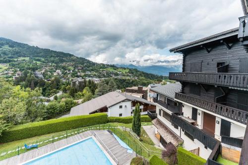 Apartment with balcony and swimming pool in summer Alpenrose residence