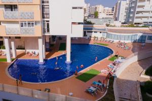 Bright 1BDR Apartment W/Balcony & Pool by LovelyStay